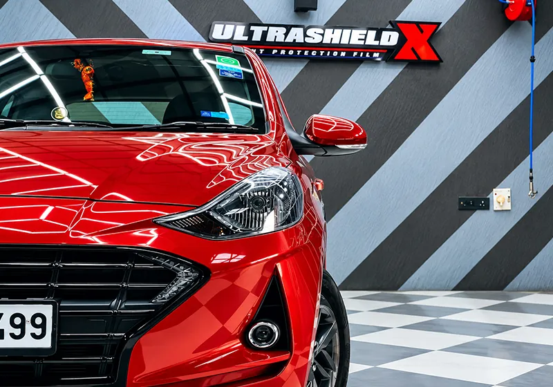 Freshly washed and detailed red hatchback at The Detailing Mafia Bommanahalli